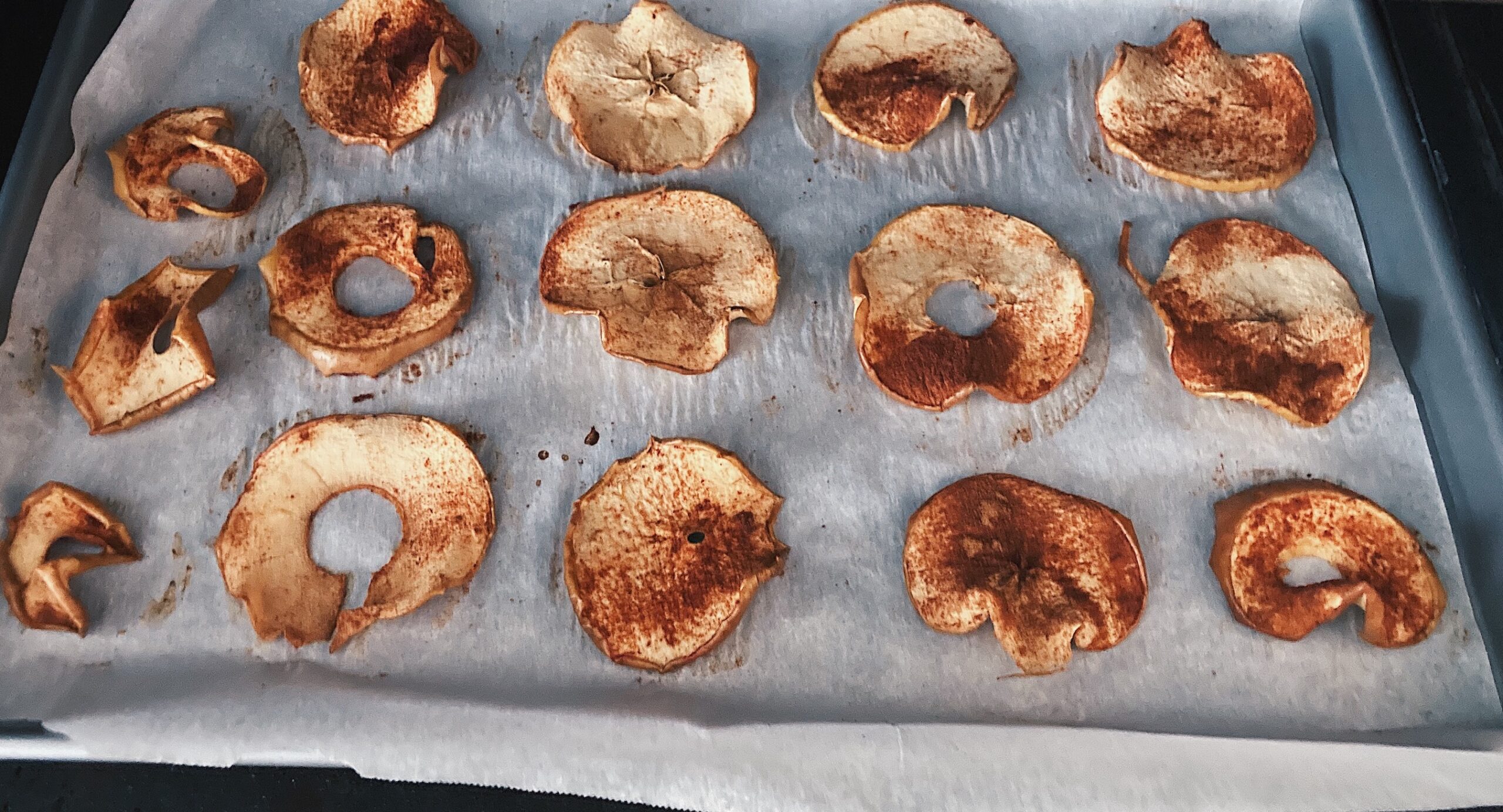 dehydrated apples in oven on tray
