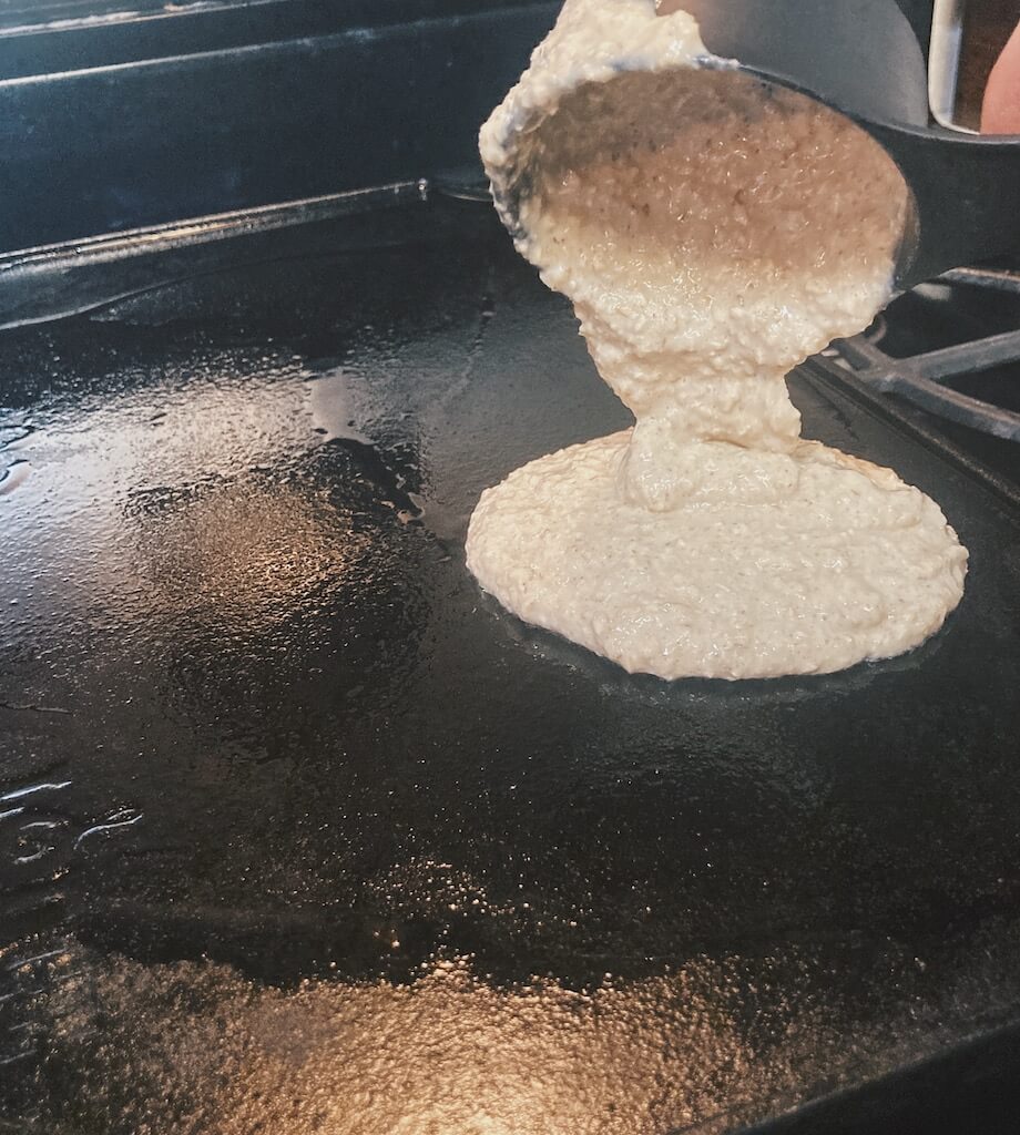 pouring pancake batter on griddle