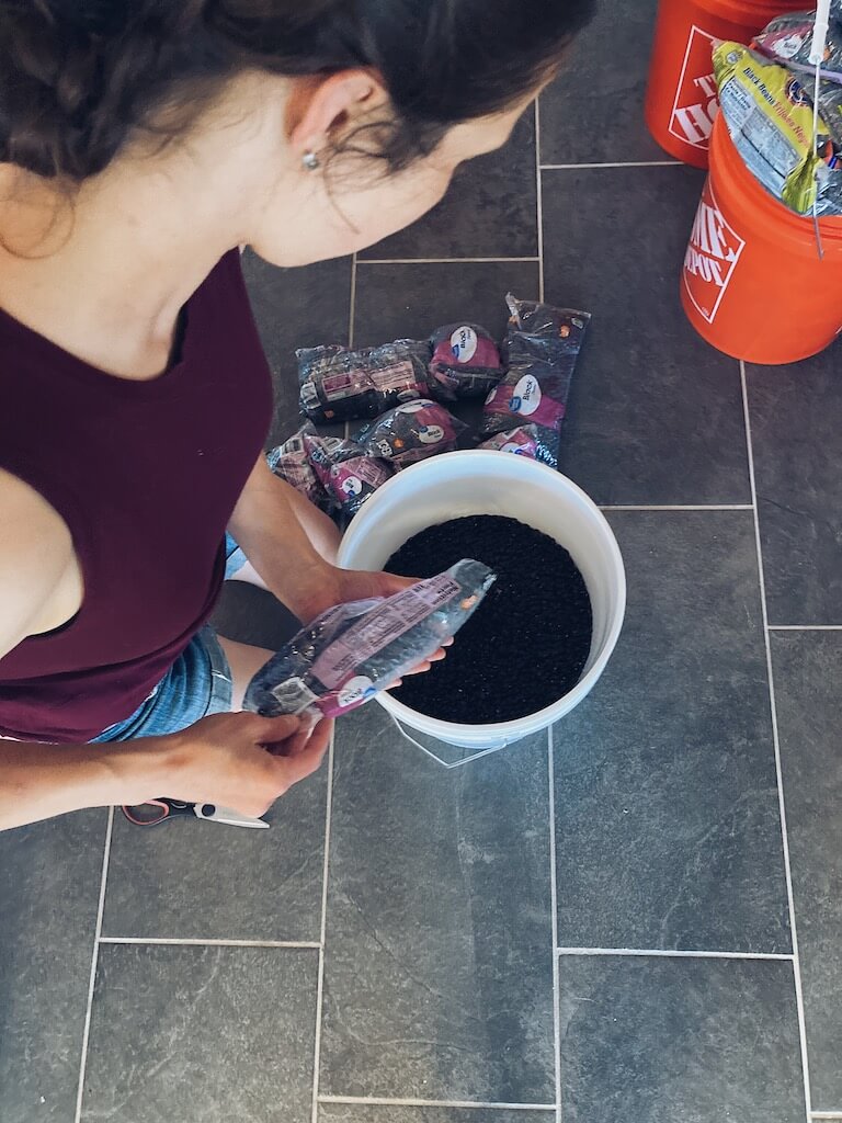 woman pouring beans into a bucket