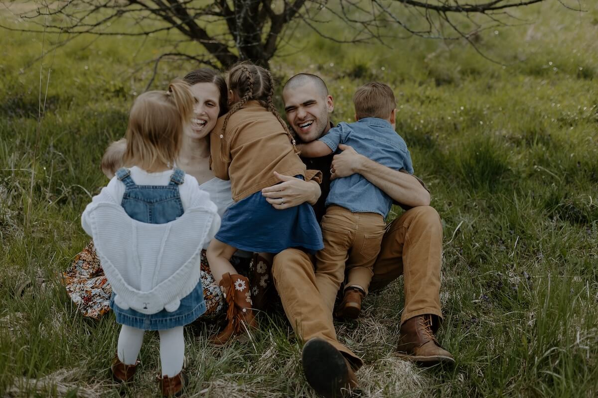 family playing in grass together