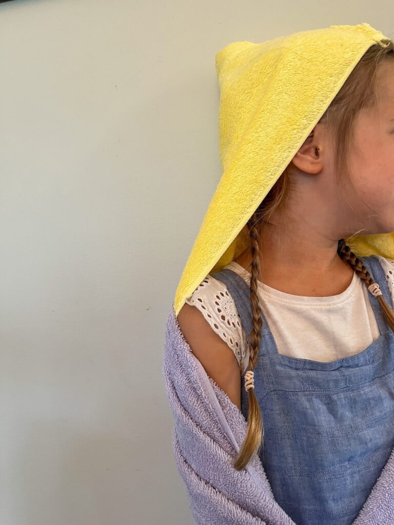 girl wearing hooded towel on her head