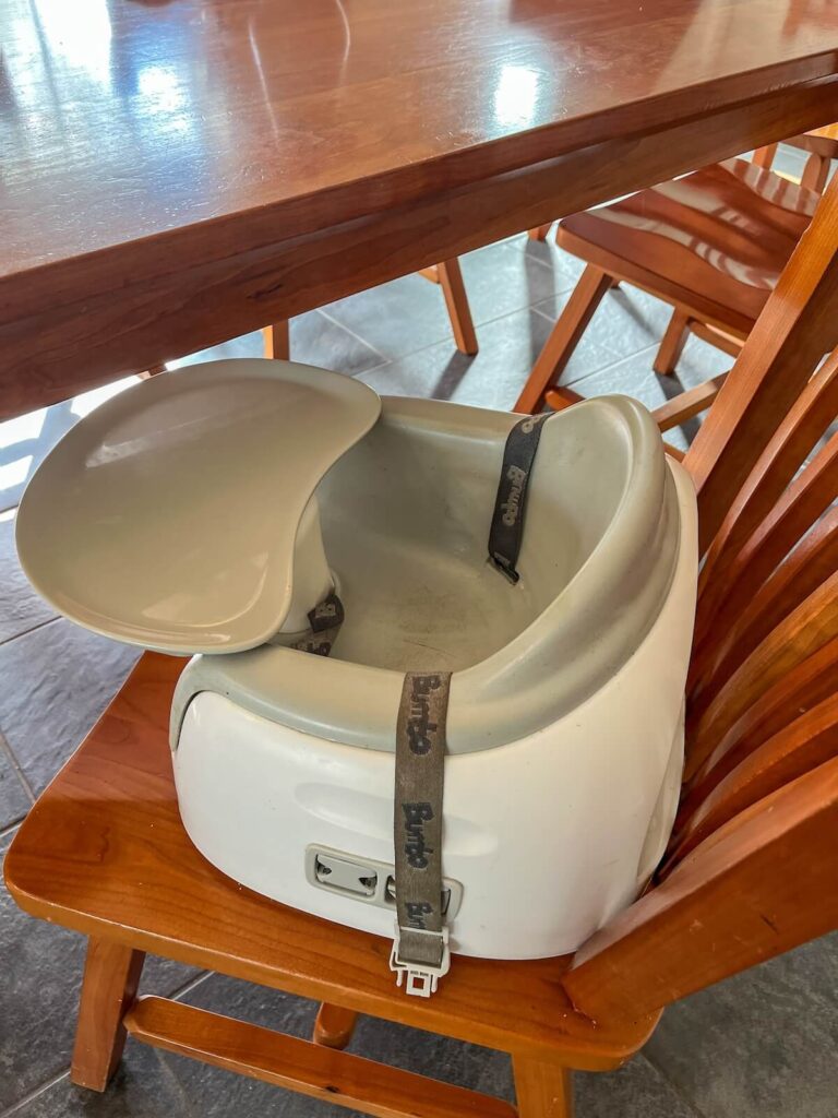 bumbo booster seat on chair