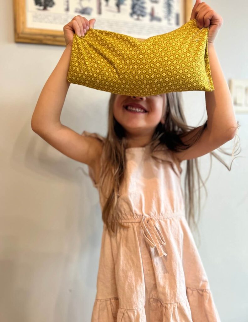 little girl holding diy rice bag