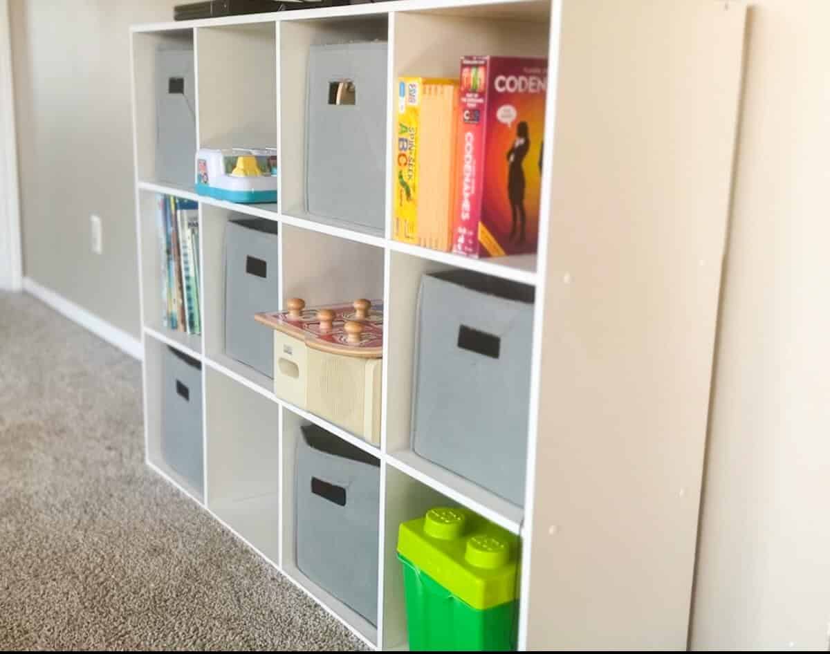 toy organizer with bins, games, duplos and puzzles