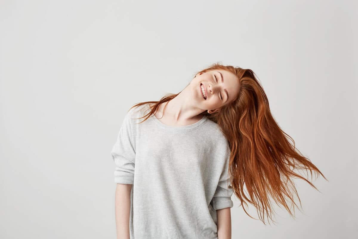 portrait-young-cheerful-beautiful-redhead-girl-smiling-with-closed-eyes-shaking-head-hair