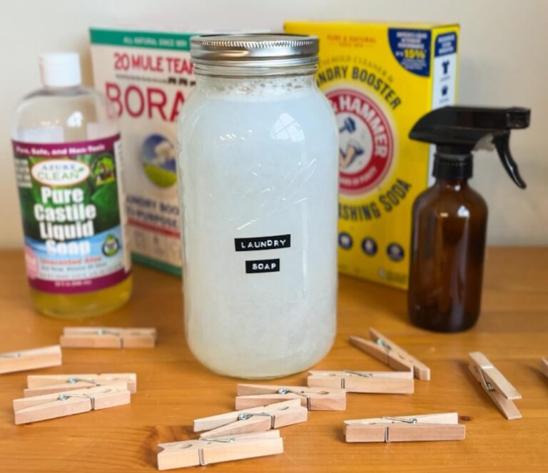 glass jar of homemade liquid laundry detergent with ingredients and clothespins