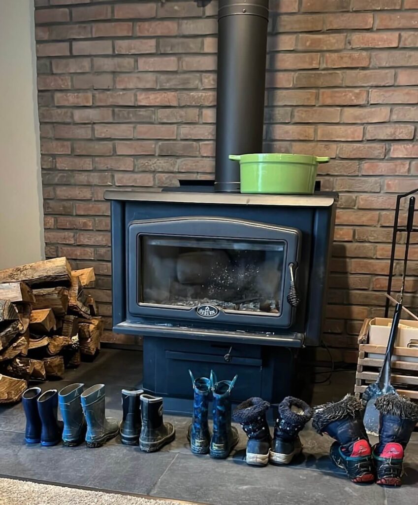 childrens boots lined up by fireplace