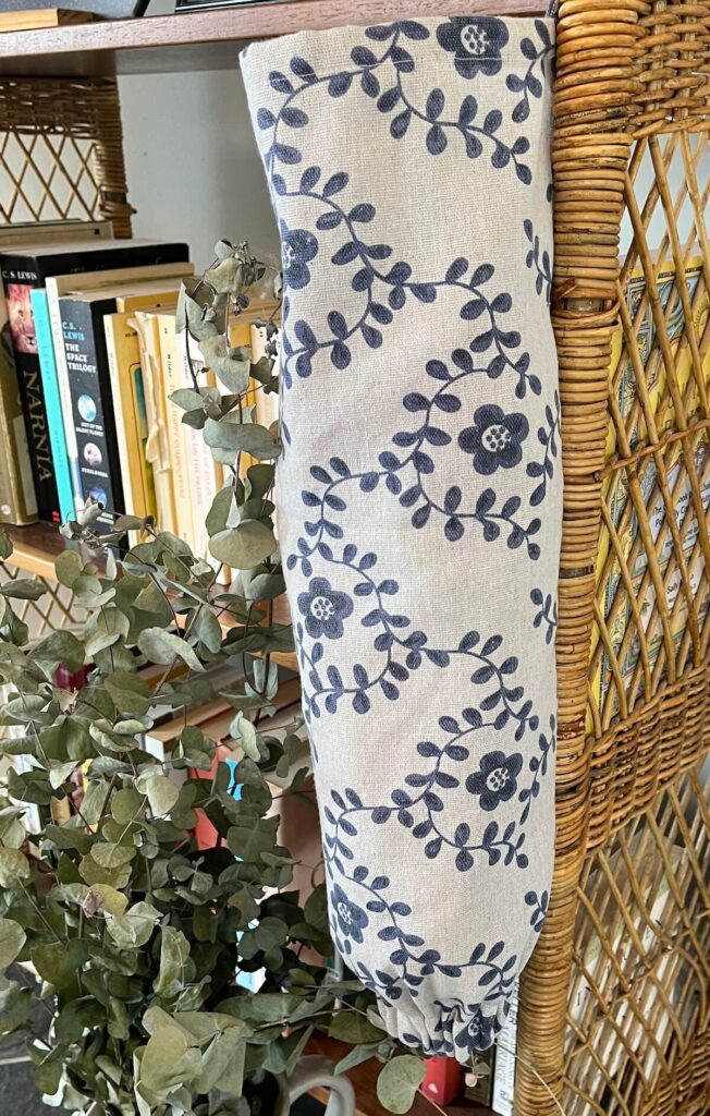 homemade bag dispenser hanging on wicker shelf