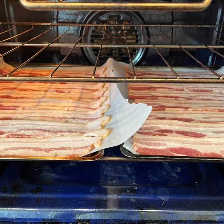 pans of bacon slices inside oven cooking